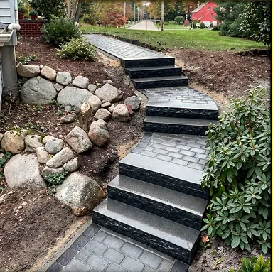 New granite steps and a paver walkway climbing a slope beside a fieldstone wall